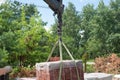 Unloading paving slabs from a truck. Men unload paving slabs using a manipulator. Workers unload building materials from Royalty Free Stock Photo