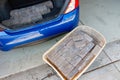 Unloading stacked grey bricks from the car