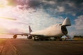 Unloading wide body transport cargo airplane in the morning sun Royalty Free Stock Photo