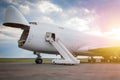 Unloading widebody cargo airplane at the airport apron in the morning sun. Freight aircraft bow compartment opened. Boarding steps Royalty Free Stock Photo