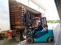 Unloading wood pallet by forklift.