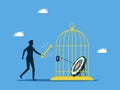 Unlock goals. man unlocking the target in the cage. concept of business