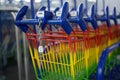 Unlock tool with chain on colorful shopping carts from a supermarket, concept for exclusion of the poor against economy, money and