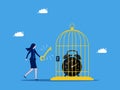 Unlock the value of time. Businesswoman uses a key to unlock a clock from a birdcage. business and investment concept