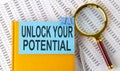 Unlock your potential text on sticker on notebook with magnifier and chart Royalty Free Stock Photo