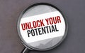 Unlock Your Potential word on paper through magnifying lens Royalty Free Stock Photo