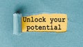 UNLOCK YOUR POTENTIAL - words written under ripped and torn paper Royalty Free Stock Photo