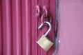 Unlocked brass padlock on a red metal door Royalty Free Stock Photo