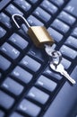 Unlocked metal padlock with keys on blue computer keyboard. Data and password protection, internet and network security concept Royalty Free Stock Photo