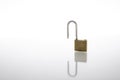 Unlocked and opened padlock as security or privacy concept, isolated on white background with reflex Royalty Free Stock Photo