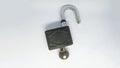 Unlocked padlock and key on the white background. Shot at a high angle or top view Royalty Free Stock Photo