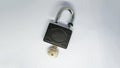 Unlocked padlock and key on the white background. Shot at a high angle or top view Royalty Free Stock Photo
