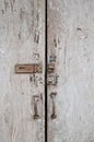 Unlocked wooden grey dirty door panes closed down Royalty Free Stock Photo