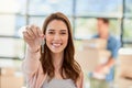 Unlocking another dream of theirs. Portrait of a young woman holding up the keys to a new home with her boyfriend in the