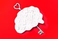 Unlocking Intelligence: Brain Puzzle with Key on Red Royalty Free Stock Photo