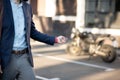 Businessman wearing dark jacket unlocking his motorcycle