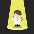 Unlucky businesswoman crying alone in spotlight.