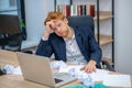 Redhaired upset young man near laptop