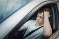 Unlucky and fatigue driver stuck in a traffic jam, looking upset out of his car window Royalty Free Stock Photo