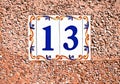 Unlucky lucky number thirteen / 13 in decorative tiles on a pink surface Royalty Free Stock Photo