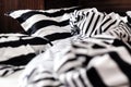 Unmade bed in black and white stripes. Close-up.