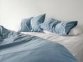 Unmade Bed With Crumpled Blue Bed Linens