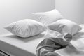 Unmade bed with soft clean white linen and pillows