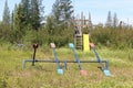 An unmaintained playground with overgrown grass Royalty Free Stock Photo