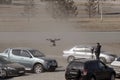 Unmanned aerial vehicle - quad copter with a camera and video broadcast is controlled by a man in a car parking in the city Royalty Free Stock Photo