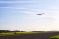 Unmanned aerial vehicle surveillance drone with light and camera landing on airport runway, ground, airfield, sunny morning