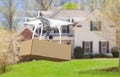 Unmanned Aircraft System UAV Quadcopter Drone Delivering Package To House Royalty Free Stock Photo