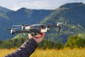 Unmanned quad with a digital camera, a tourist holds in his hand