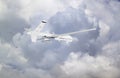 unmanned RC military drone flies against the backdrop of blue peaceful sky with rainy grey ominous clouds