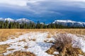 Unmelted snow grassland with beautiful cloudscape in late autumn sunny day. Royalty Free Stock Photo