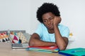 Unmotivated african american male student at desk