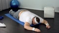 Unmotivated man lying on mat, giving up during exhausted muscles training Royalty Free Stock Photo