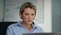 Unmotivated office worker looking laptop sitting workplace closeup. Lady reading