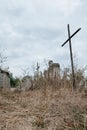 Unnamed gravestones with metal and stone crosses on old abandoned city or village cemetery. Weathered stone cross on Royalty Free Stock Photo