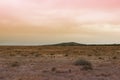 Unnatural arid landscape with weird sky color