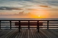 Unoccupied bench offers serene ocean view on pier