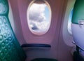 Unoccupied seat near the window in a plane with clouds