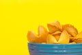 Unopened fortune cookies in a blue ceramic bowl. Royalty Free Stock Photo