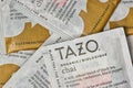 Unopened Tazo chai flavor tea bag square packets scattered loosely.