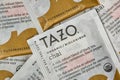 Unopened Tazo chai flavor tea bag square packets scattered loosely.