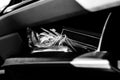 Unorganized mess inside an open glove compartment of a vehicle Royalty Free Stock Photo