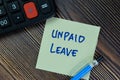 Unpaid Leave write on sticky notes isolated on Wooden Table