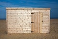 Unpainted beach hut. New wooden shed on the sand. Royalty Free Stock Photo