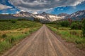Unpaved county roads towards Rocky Mountains Range in Colorado, USA Royalty Free Stock Photo