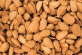 Unpeeled Almond Nuts Background. Natural Fresh Brown Nuts Nutshells. Royalty Free Stock Photo