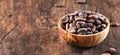 Unpeeled cocoa bean on wooden rustic background, close-up. Copy space Royalty Free Stock Photo